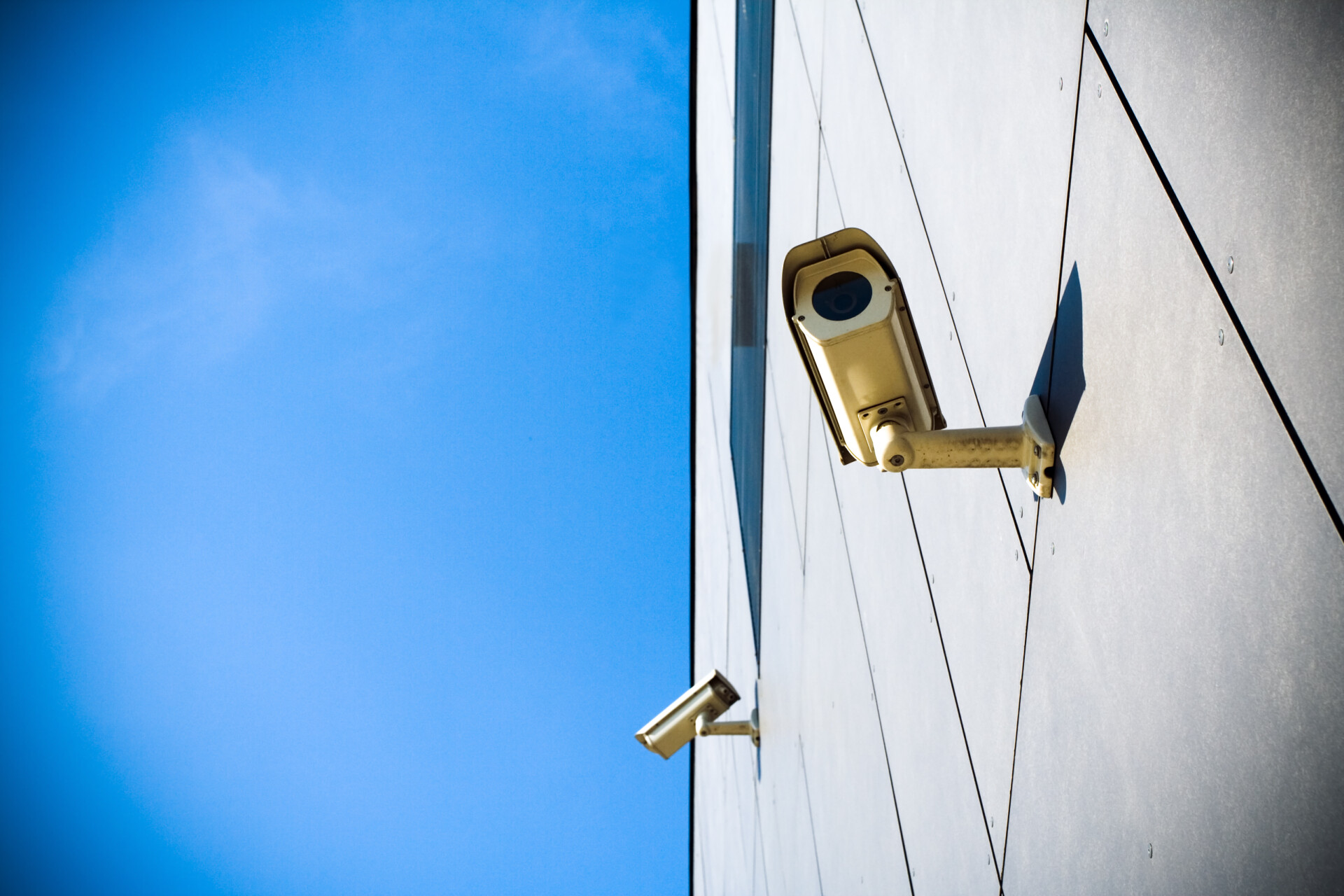 Security cameras affixed to building on sunny day 2026 01 05 00 25 57 utc